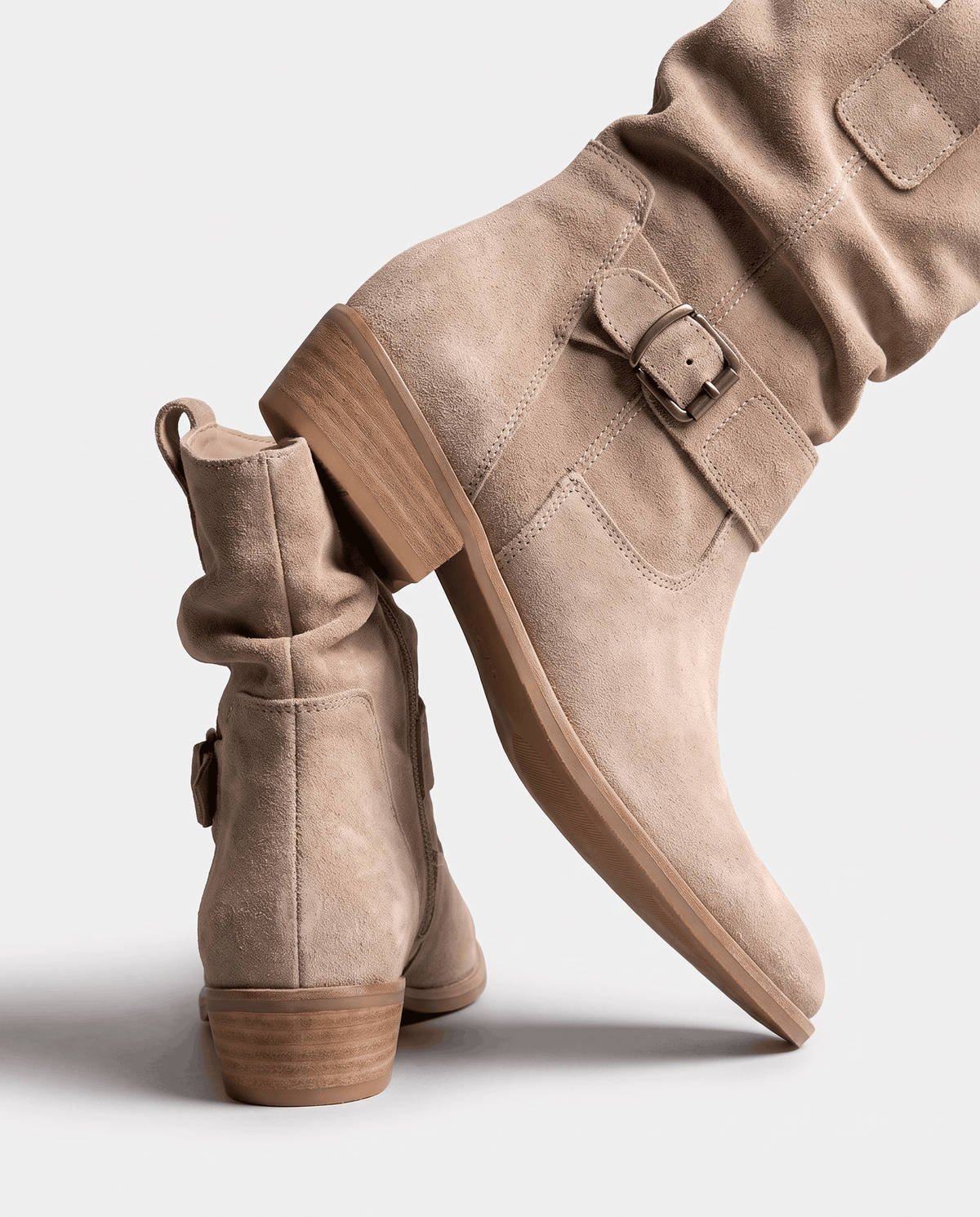 Beige suede boots shown from the side to highlight the block heel