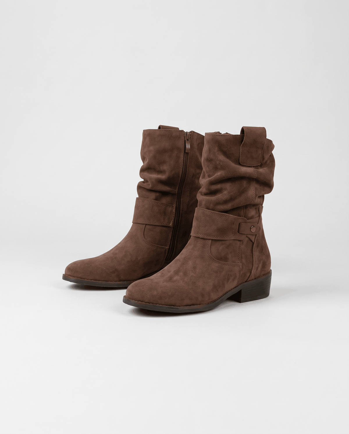 Brown suede slouch boots angled to show the relaxed shaft