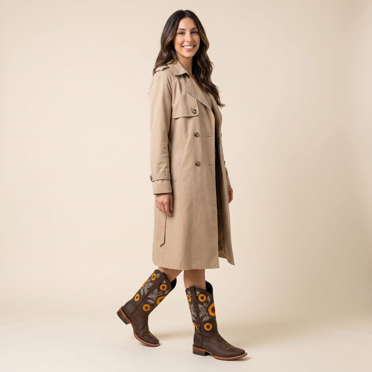 Woman in a beige trench coat styled with dark brown sunflower boots