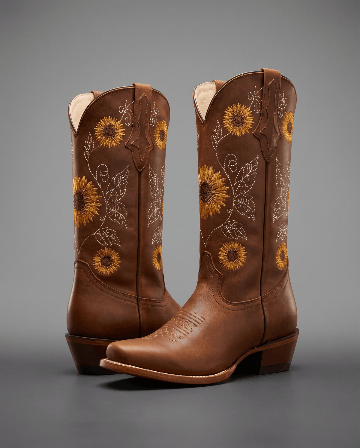 Khaki pair on a gray backdrop showing the sunflower and vine embroidery