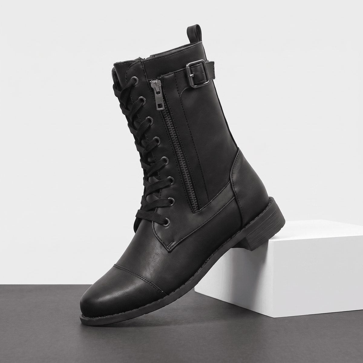 Black vegan leather lace-up combat boot with side zipper and block heel.