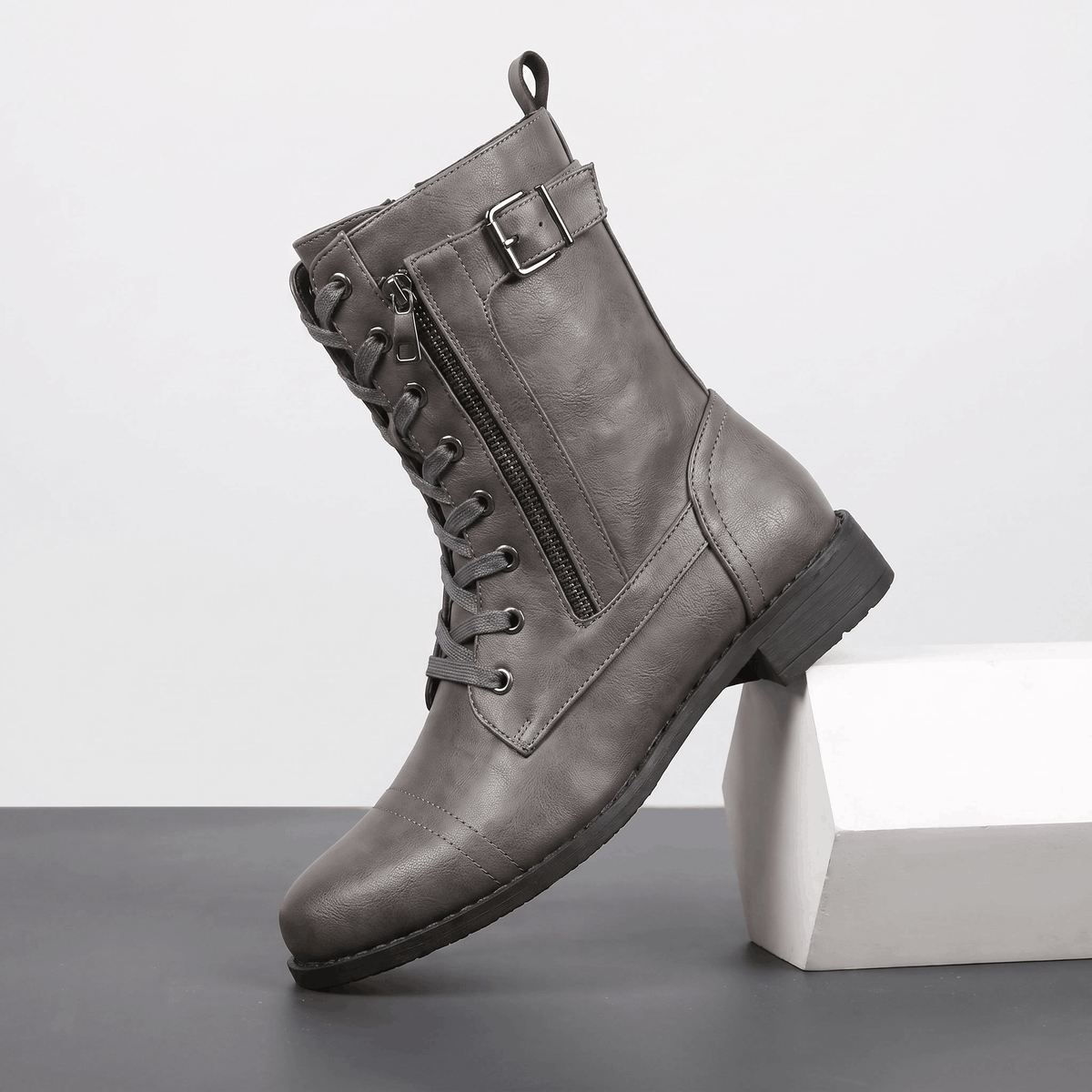Gray vegan leather lace-up combat boot with side zipper and block heel.