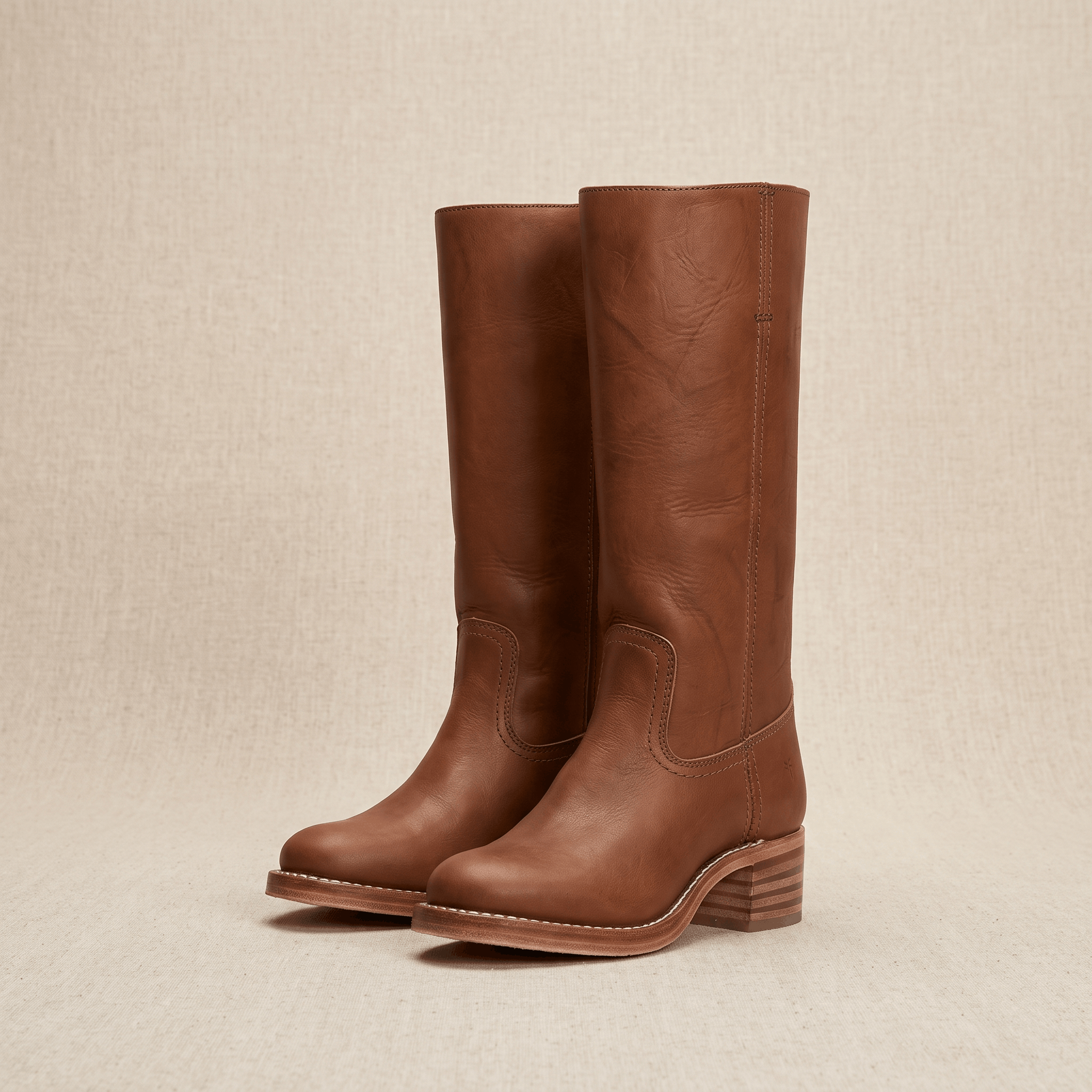 Dark brown vegan leather knee-high riding boots with low block heels.