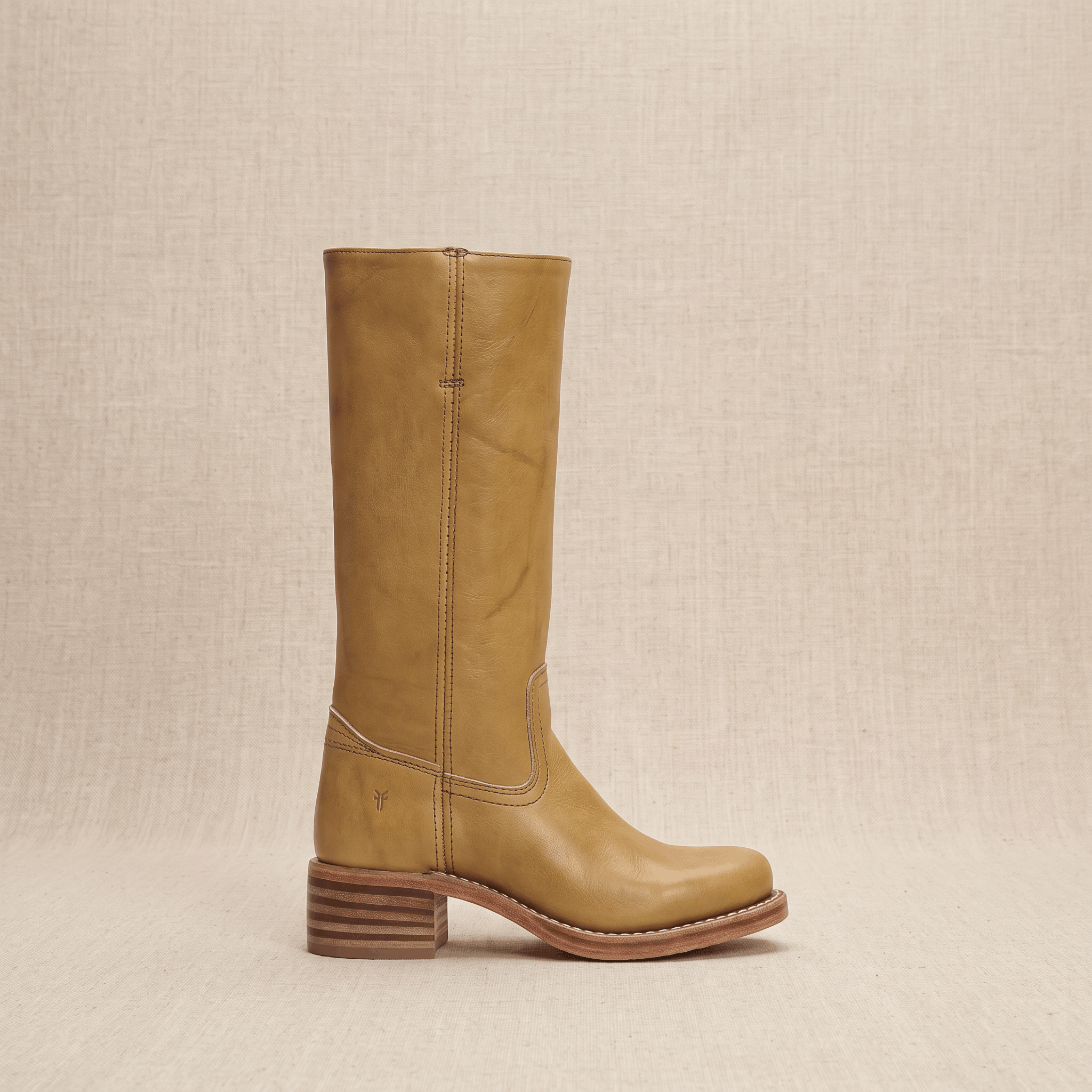Single tan vegan leather knee-high riding boot shown in side profile.
