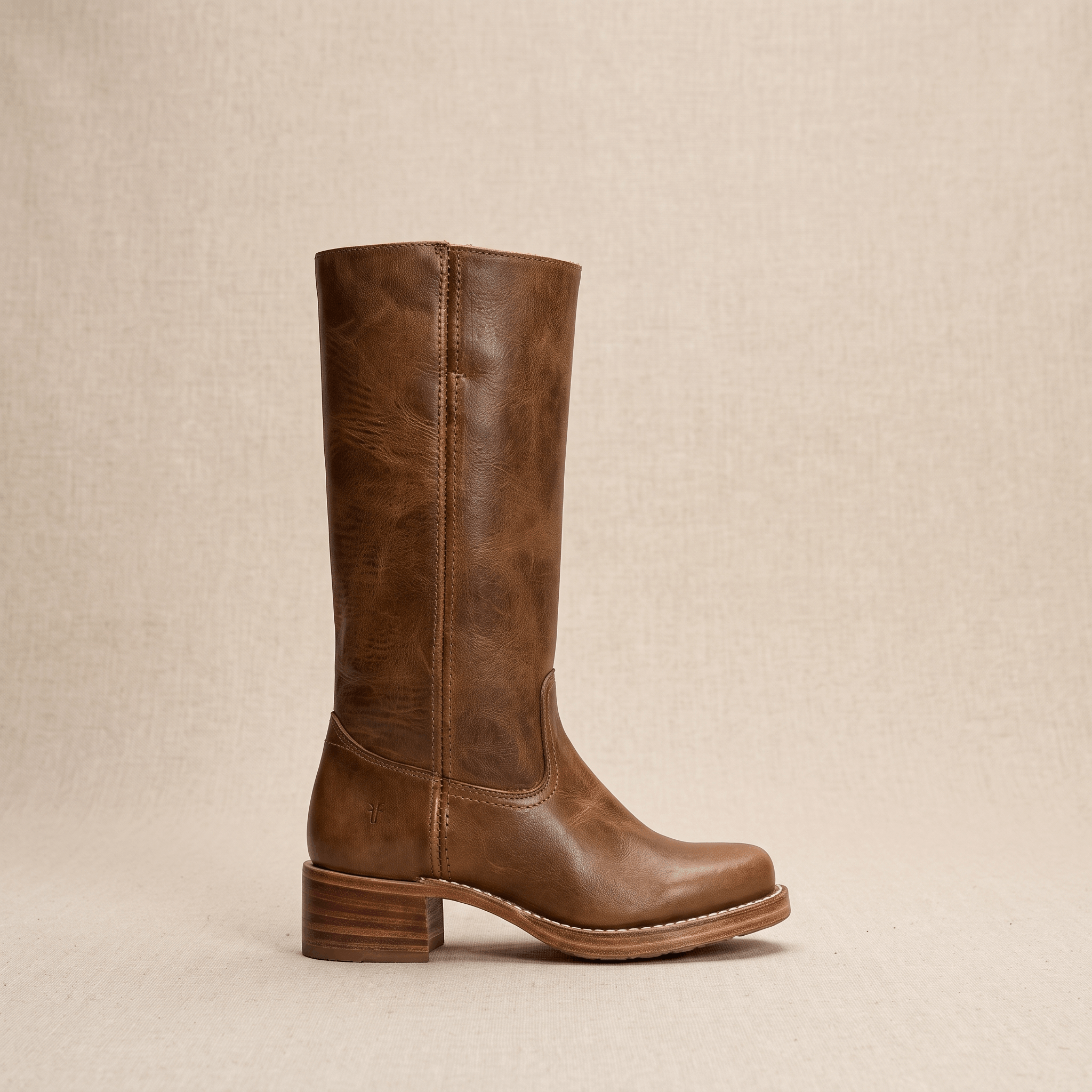Single brown vegan leather knee-high riding boot shown in side profile.