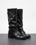 Black vegan leather mid-calf boots with ruched slouch shafts, dual buckle straps, and stacked block heels.