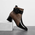 Brown croc-embossed vegan leather ankle boot with a square toe, chunky block heel, and buckle detail.