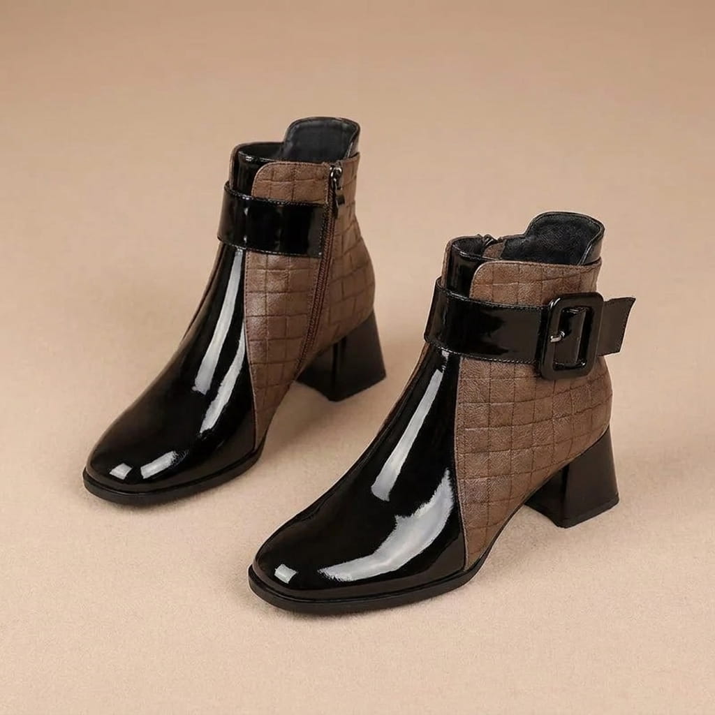 Brown and black two-tone vegan leather ankle boots with croc-embossed panels and block heels.