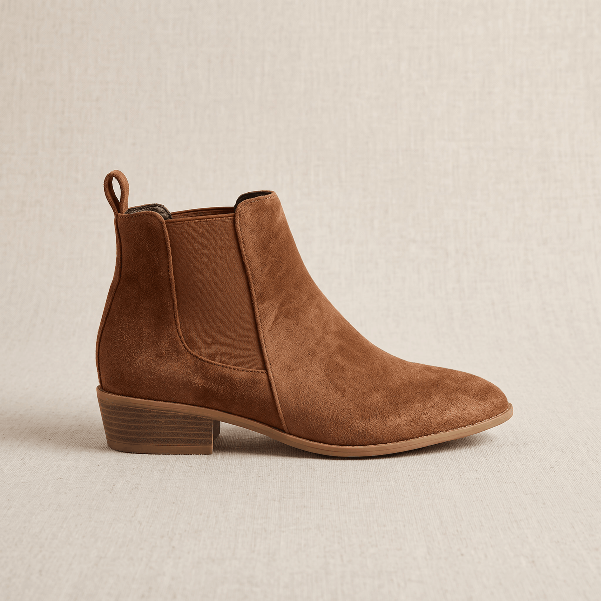 Side view of brown vegan suede Chelsea boots with a block heel.