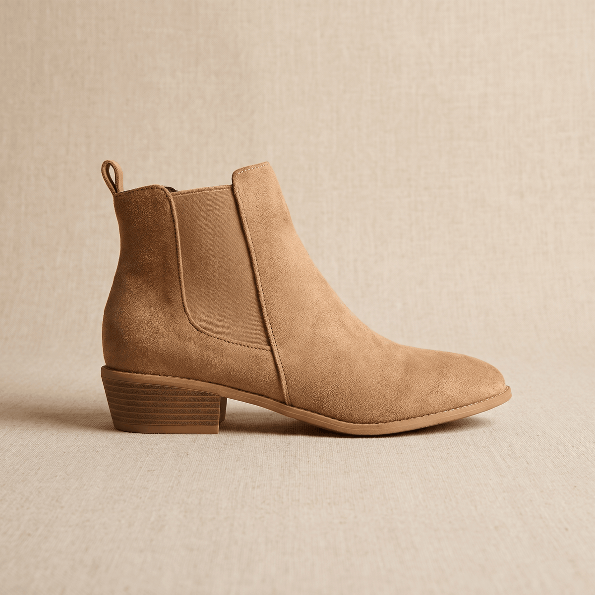 Single beige vegan suede Chelsea boot displayed on a neutral background.