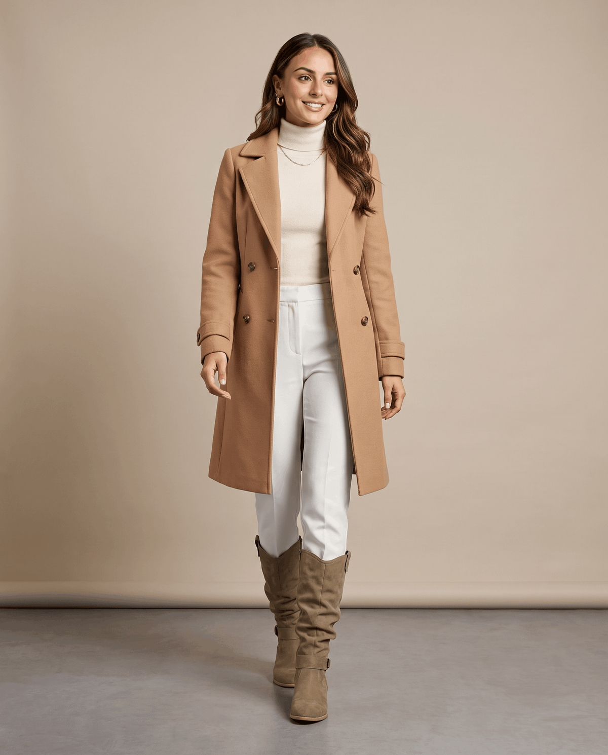 Woman wearing taupe vegan suede knee-high slouch boots with a long coat in a minimalist setting.