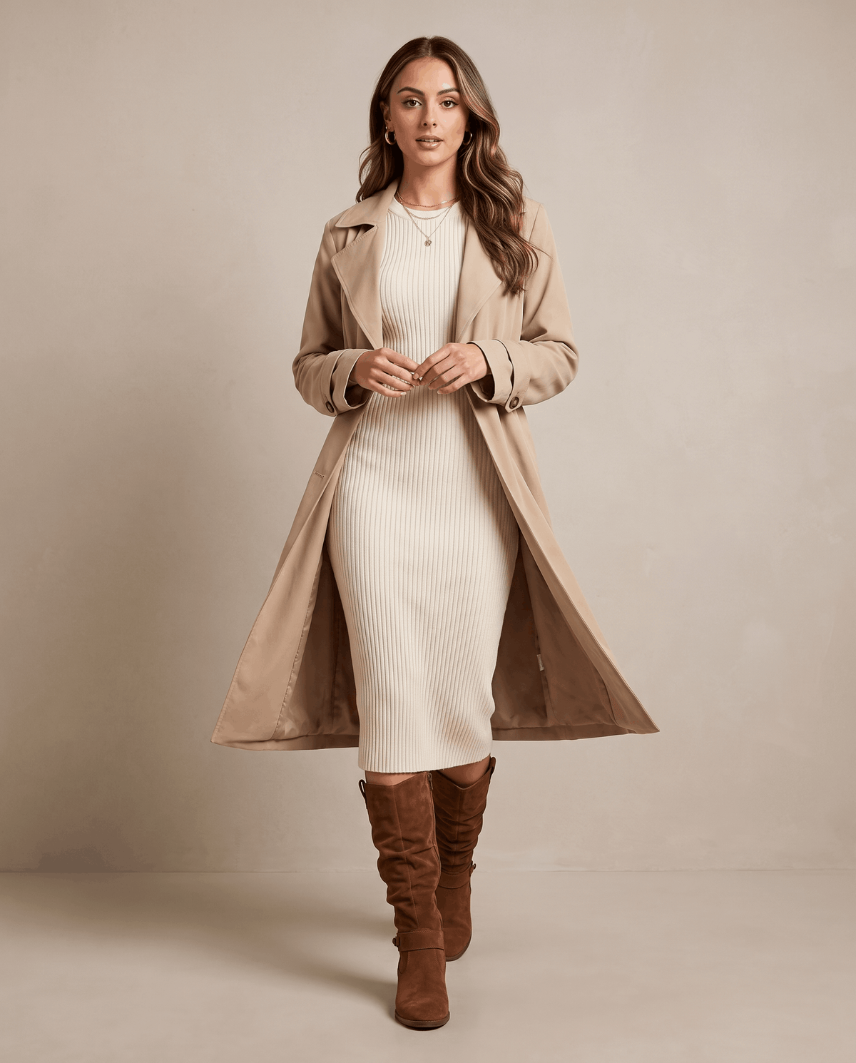 Woman wearing dark brown vegan suede knee-high slouch boots with a long beige coat.