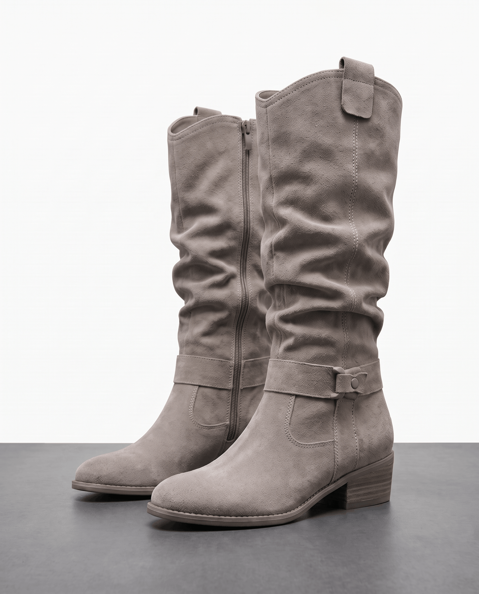 Gray vegan suede knee-high slouch boots with a side zip and ankle strap, displayed against a white studio background.