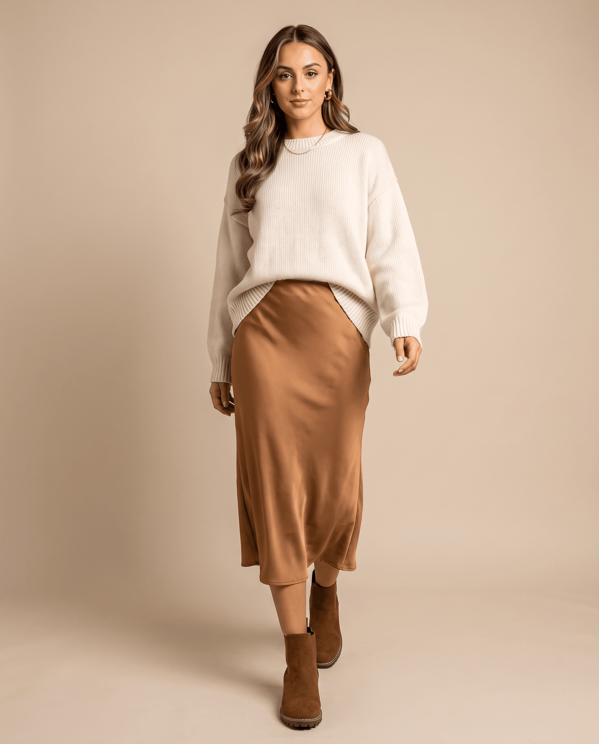 Brown vegan suede Chelsea boots with a block heel, lug outsole, and elastic side panels worn with a satin midi skirt.