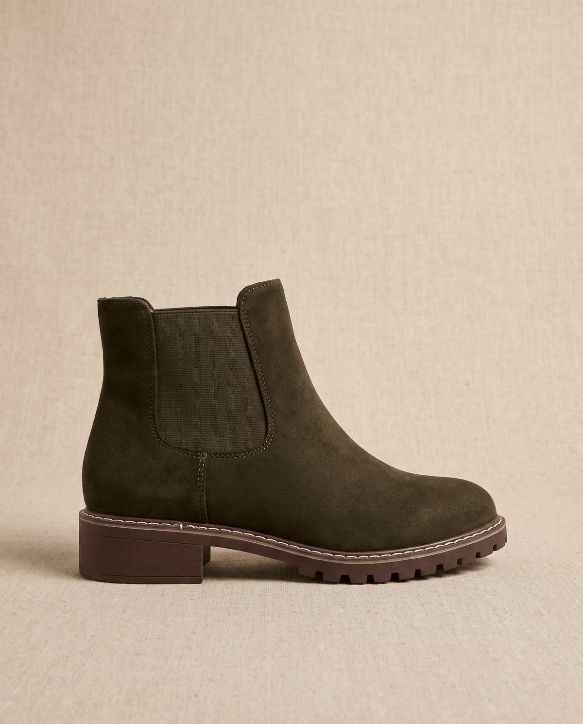 Dark brown vegan suede Chelsea boot with elastic side panels, a stitched welt, and a chunky lug outsole.