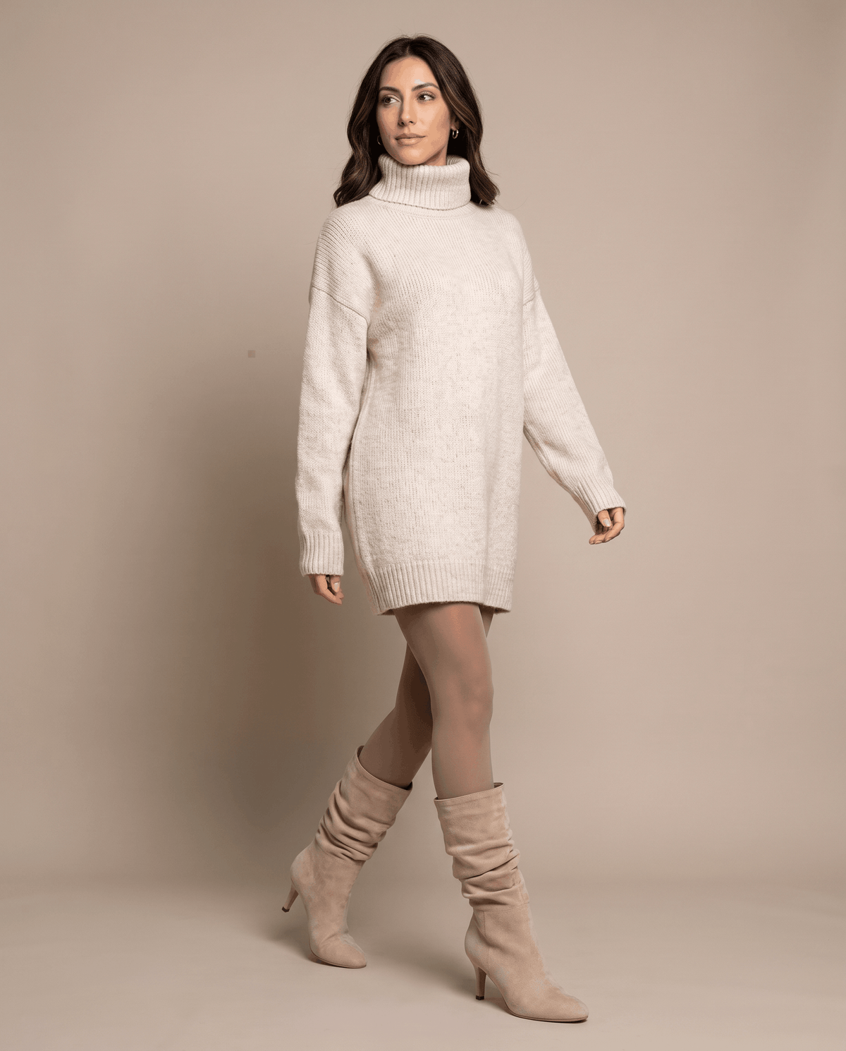 Vegan suede mid-calf boots in light beige with a slouchy shaft, almond toe, and slim flared heel on a neutral studio backdrop.