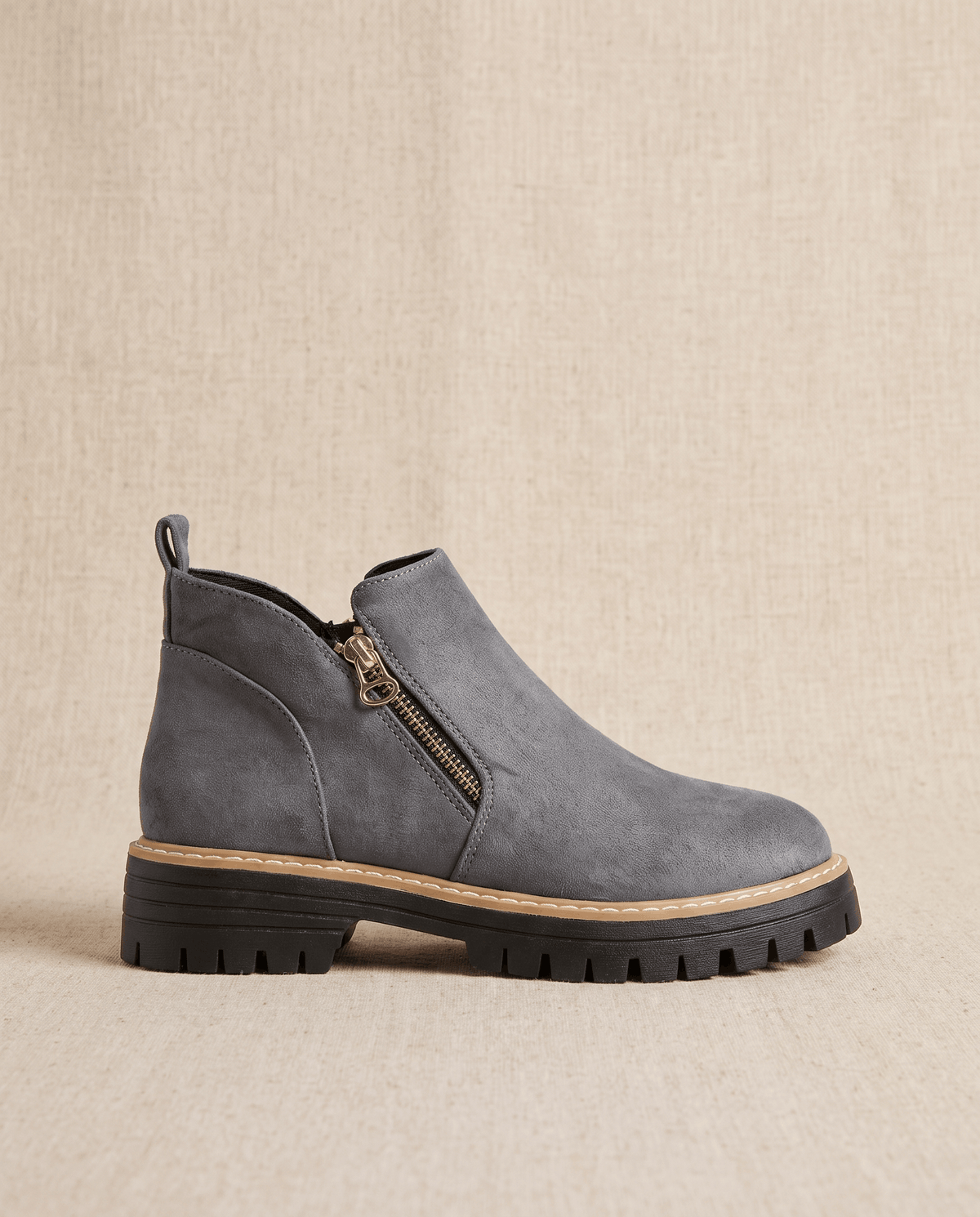 Gray vegan suede ankle boot with a side zip, chunky lug platform, and cushioned wedge sole on a neutral background.