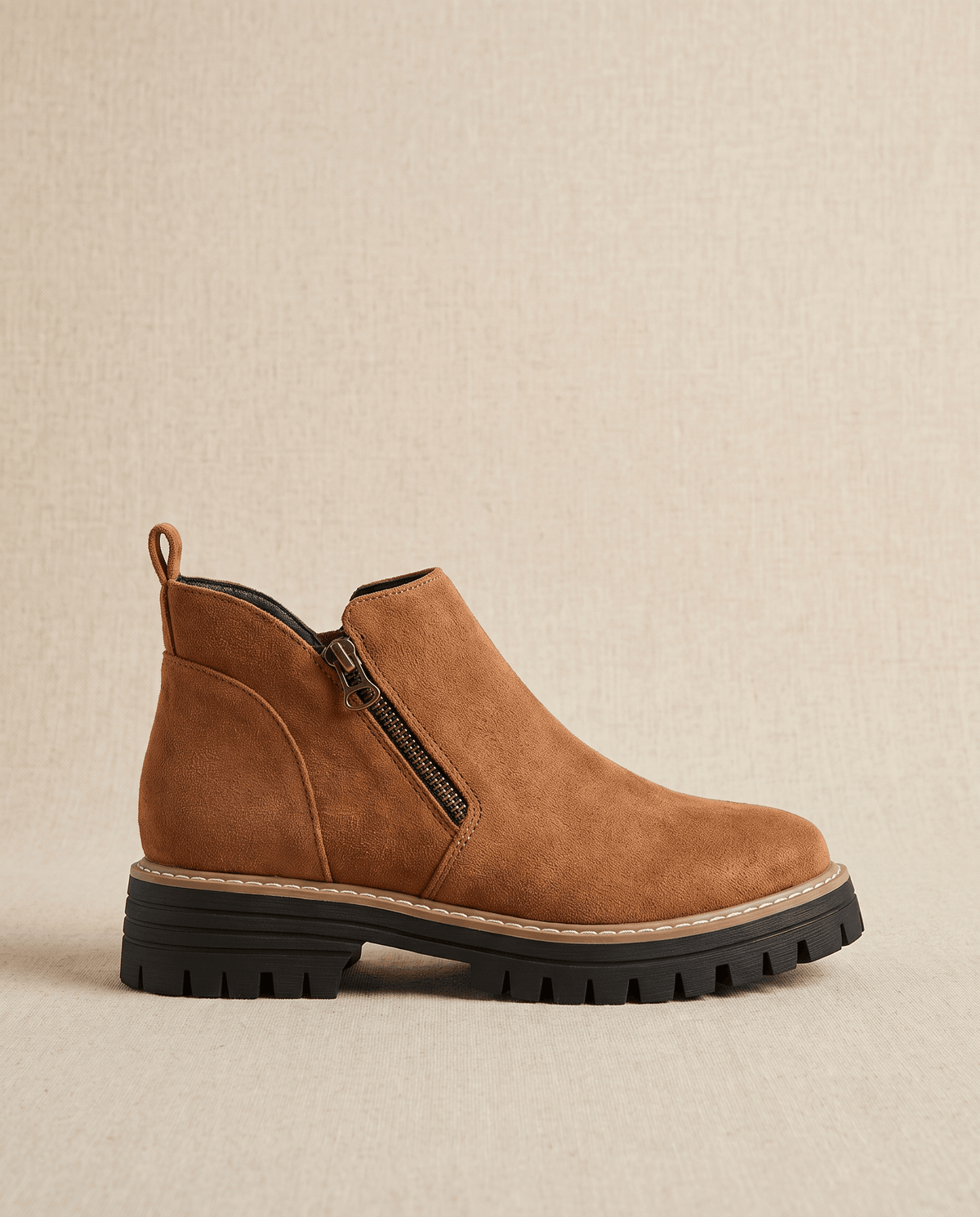 Tan vegan suede ankle boots with a side zip, chunky lug platform, and cushioned wedge sole on a neutral background.
