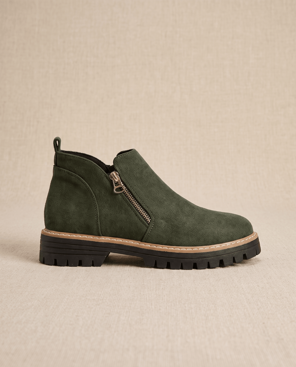 Green vegan suede ankle boot with a full side zip, chunky lug platform, and cushioned wedge sole on a neutral background.