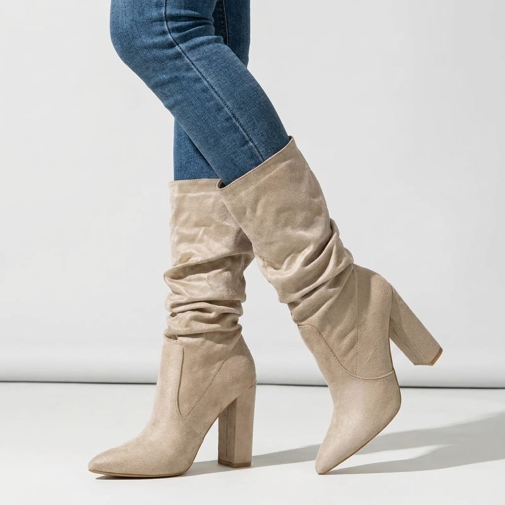 Woman wearing beige vegan suede slouchy mid-calf boots with blue jeans.