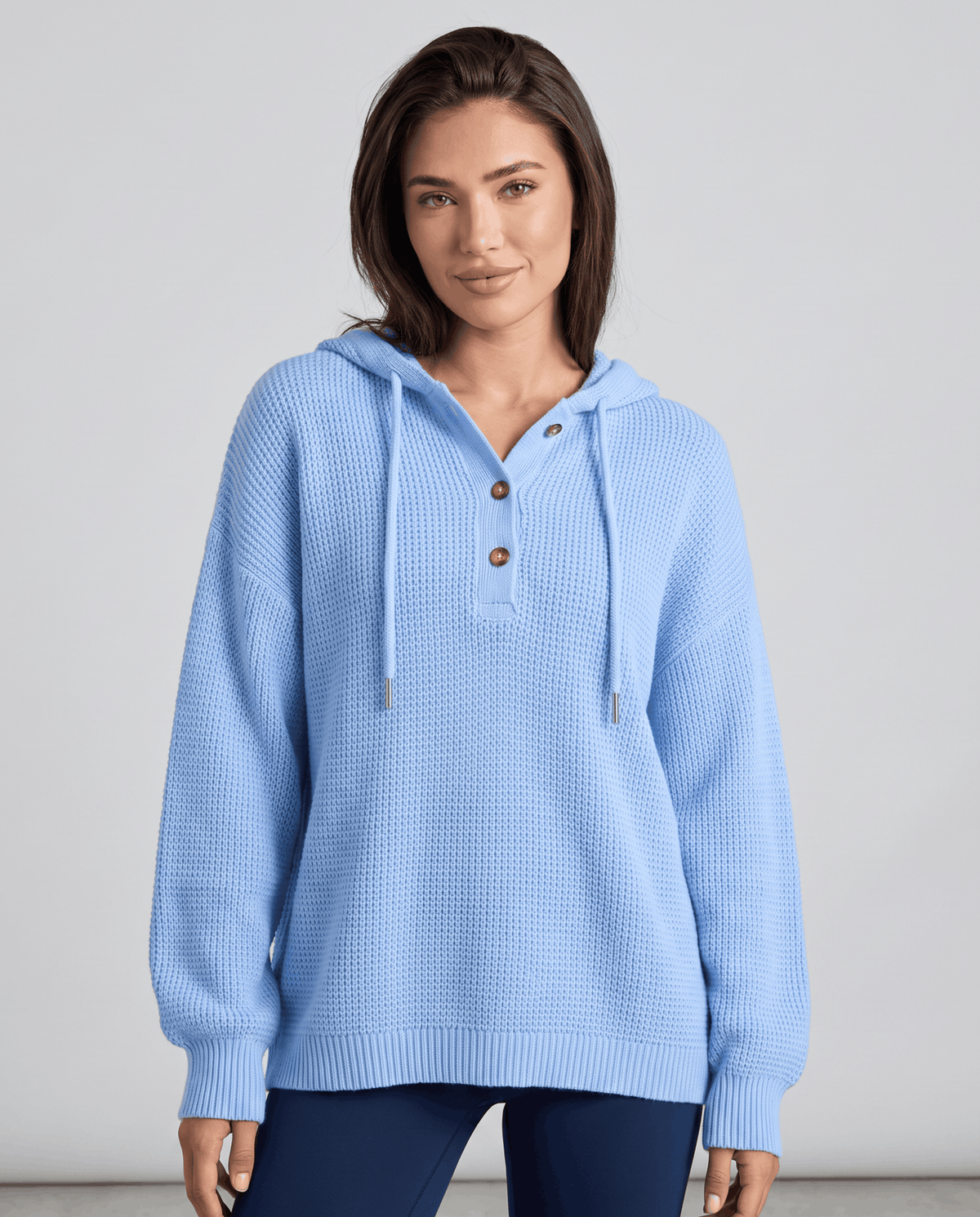 Women's waffle knit hoodie in light blue with buttoned neckline and drawstrings, front view