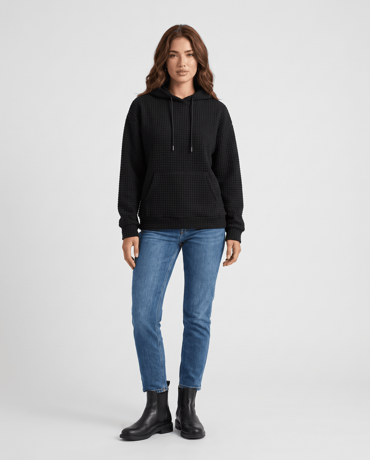 Full-length black hoodie styled with blue jeans and black ankle boots
