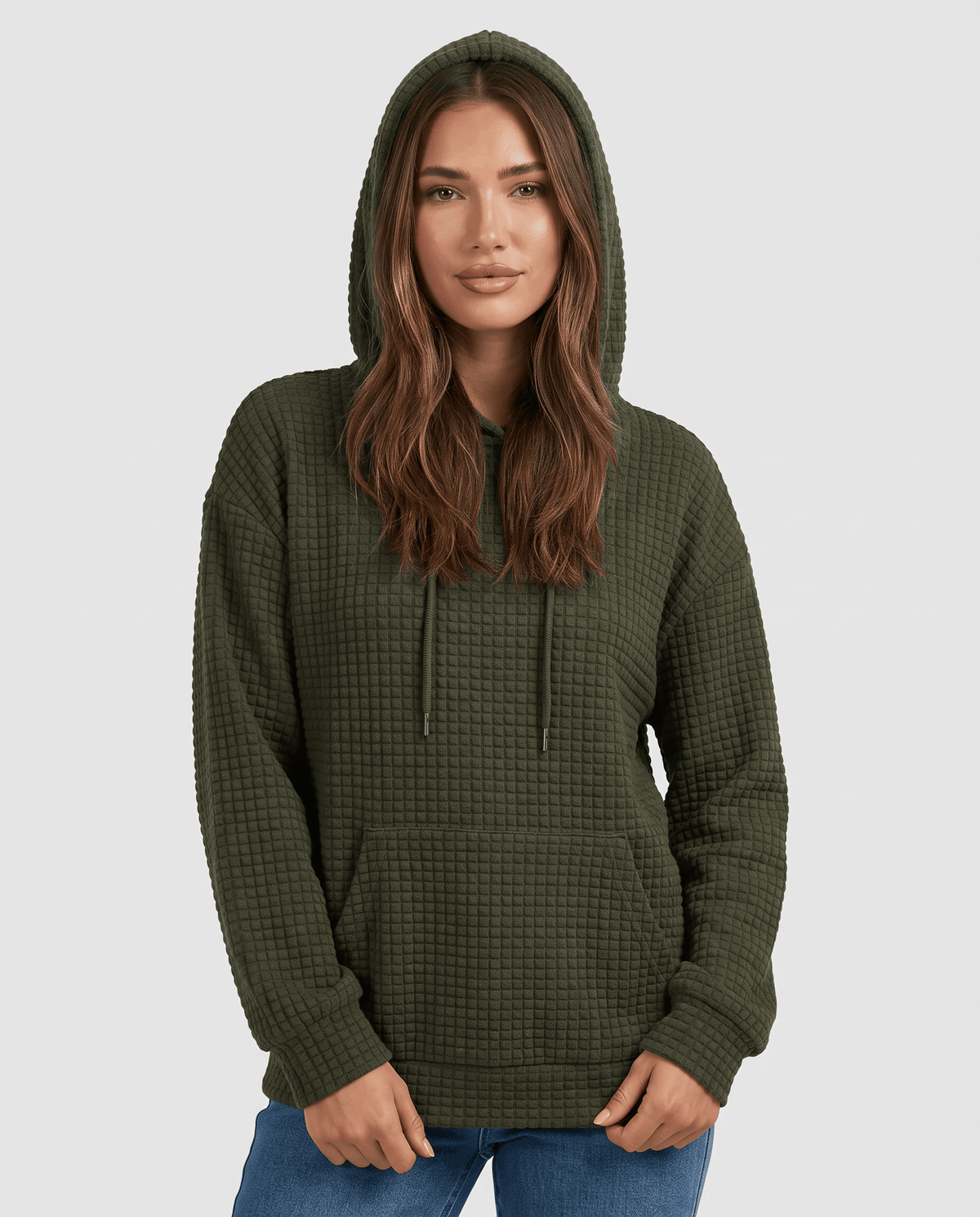Front view of dark green waffle knit hoodie worn with the hood up