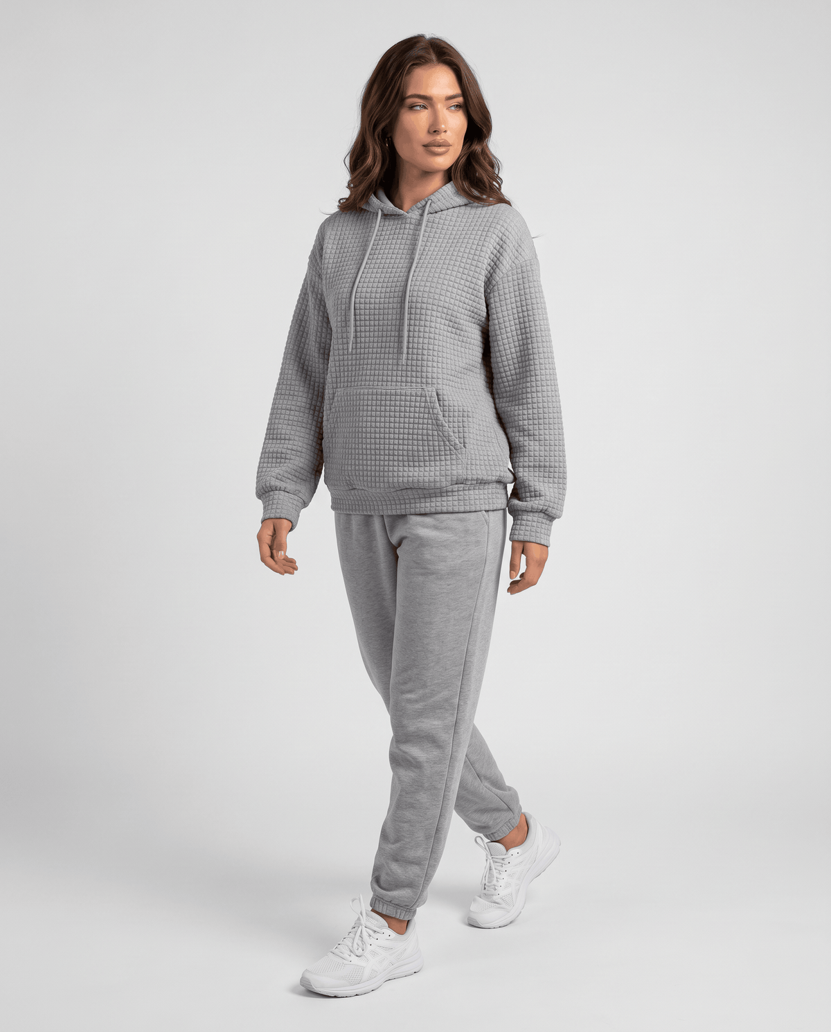 Full-length gray hoodie styled with matching gray joggers and sneakers