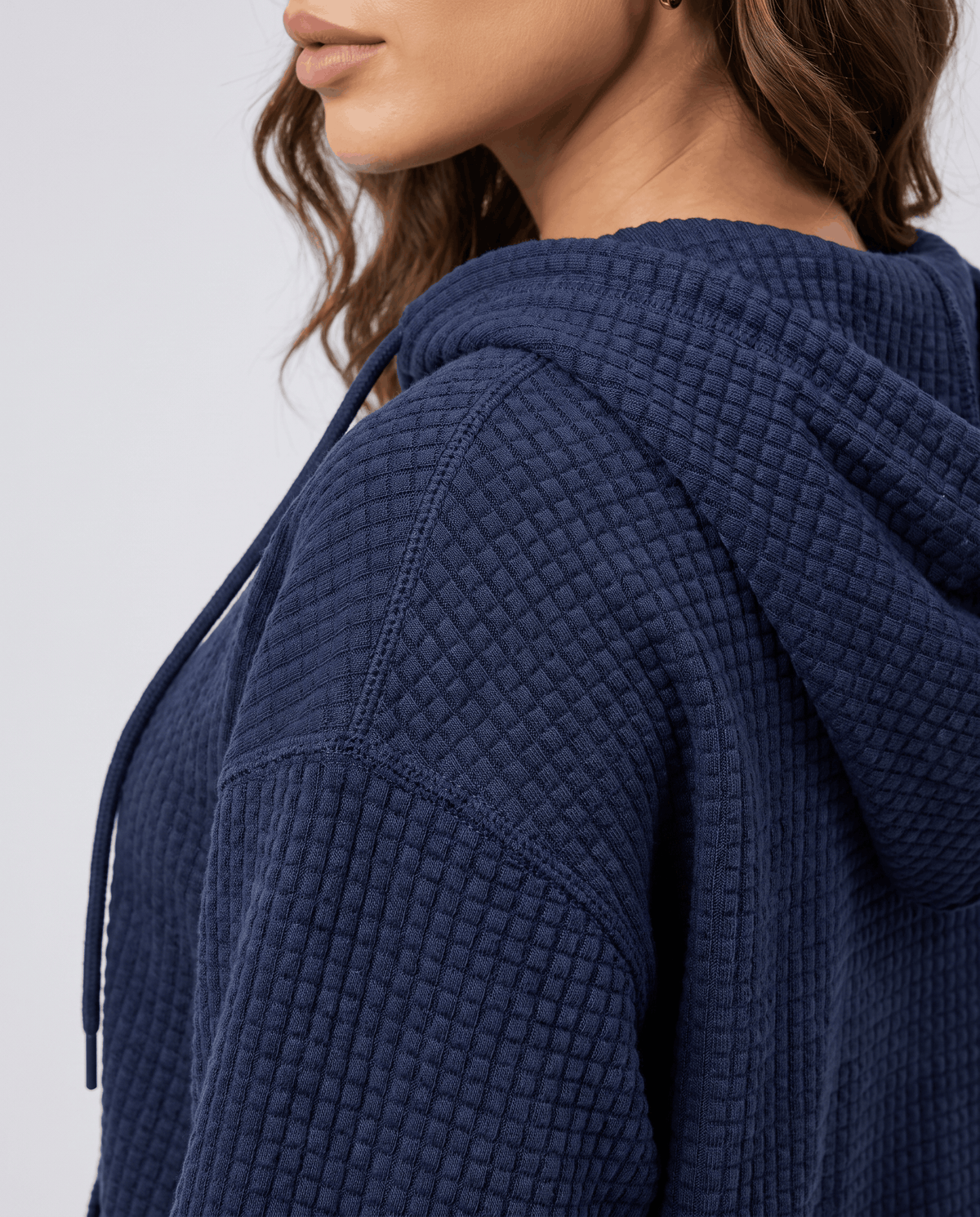 Side close-up of navy blue hood showing the waffle knit texture and drawstring