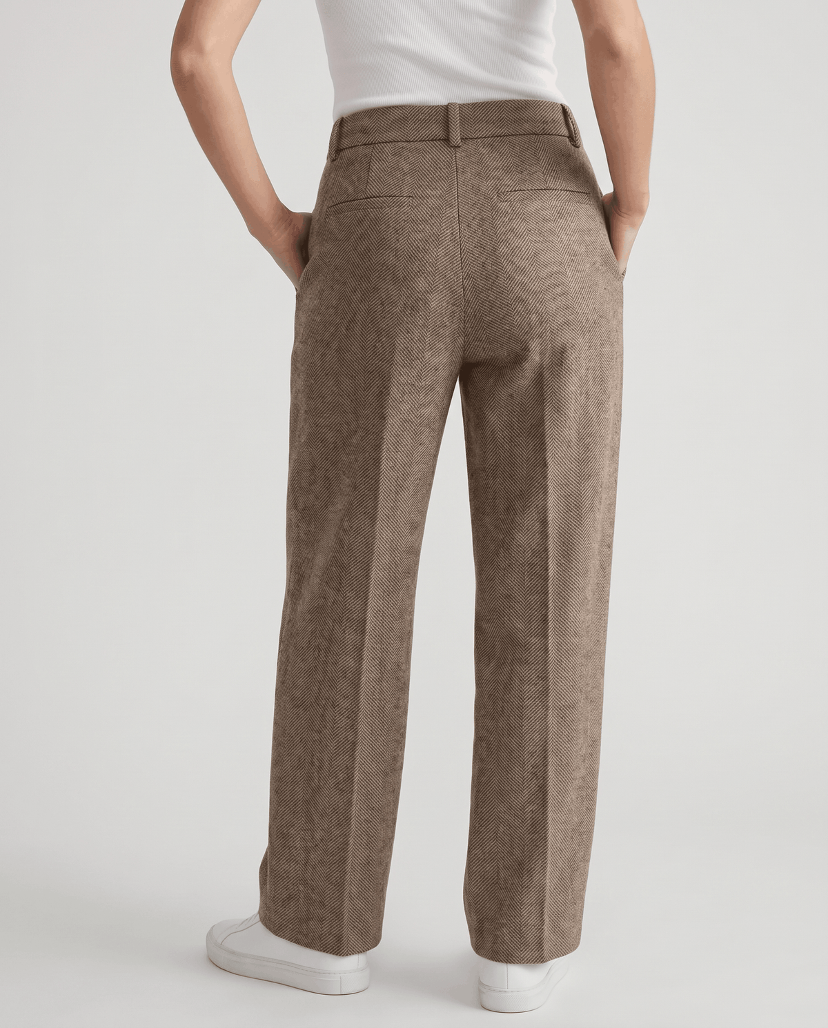Full back view of camel straight-leg trousers with white sneakers