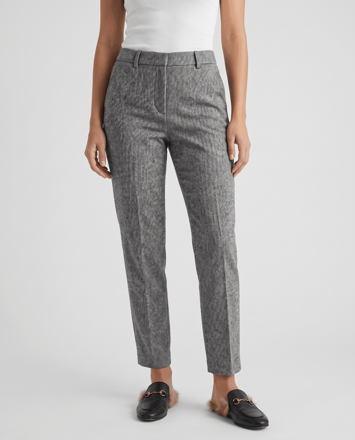 Gray herringbone trousers in front view with black horsebit loafers