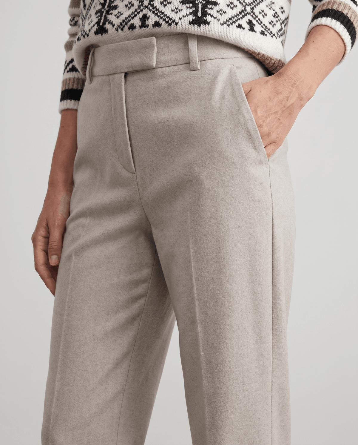 Front close-up of ivory trousers with belt loops and slant pocket