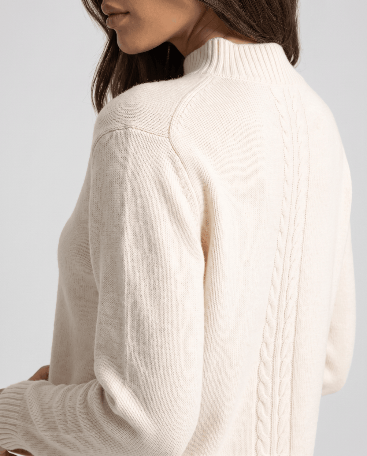 Close-up of the cable detail down the back of the beige wool pullover