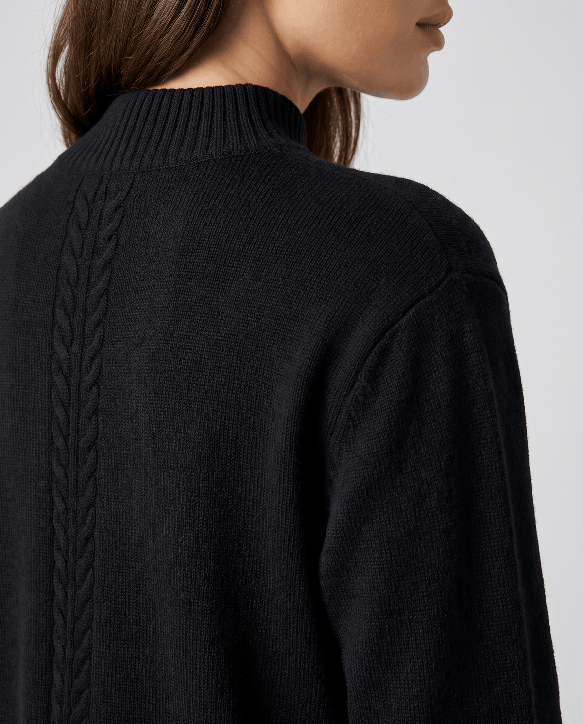 Close-up of the cable detail down the back of the black wool pullover