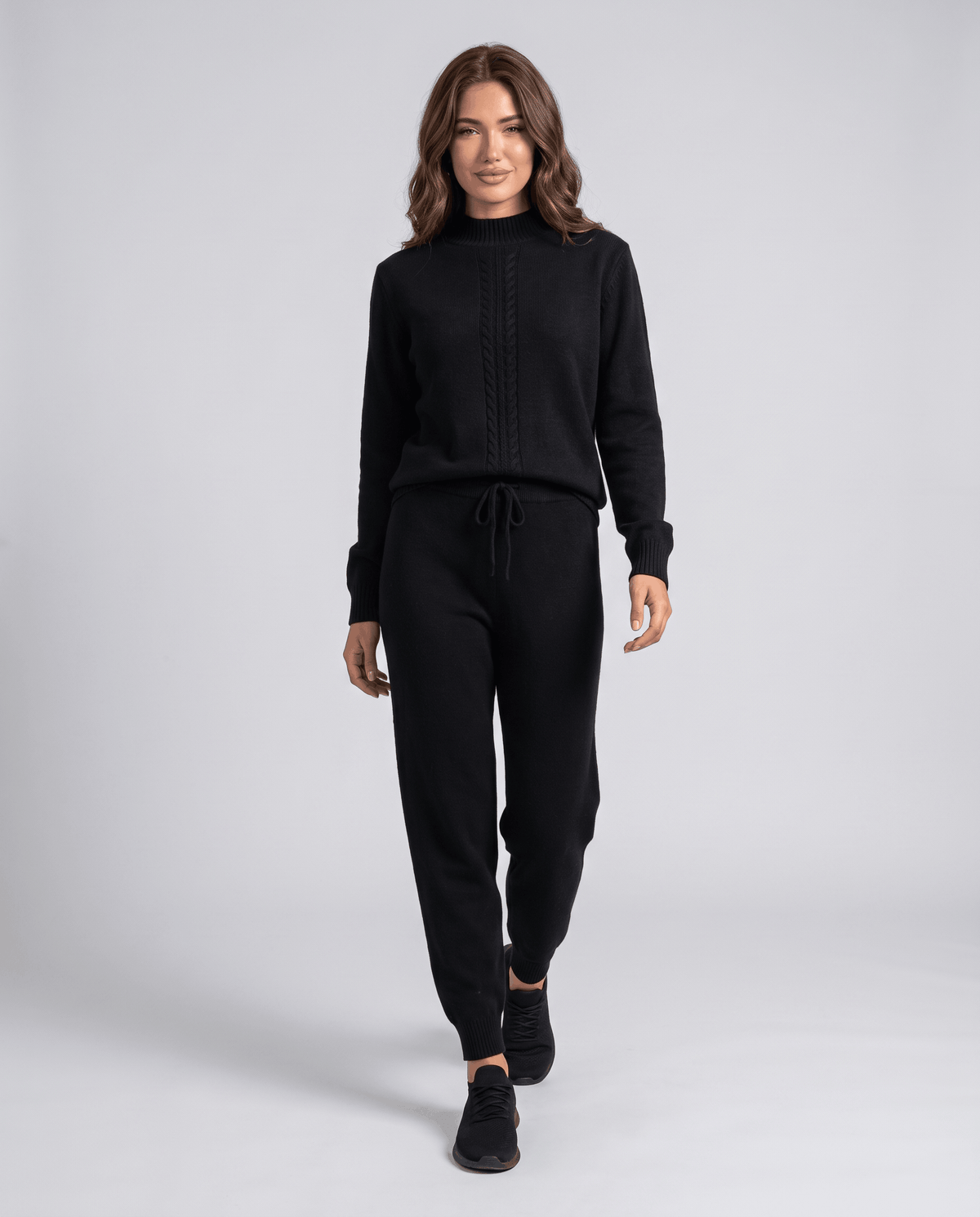 Black wool loungewear set with a mock-neck pullover and drawstring pants, walking front view