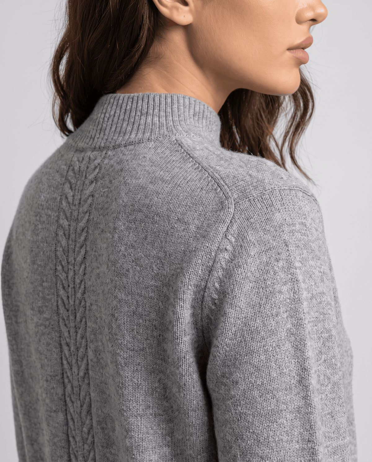 Close-up of the shoulder and cable detail on the gray wool pullover