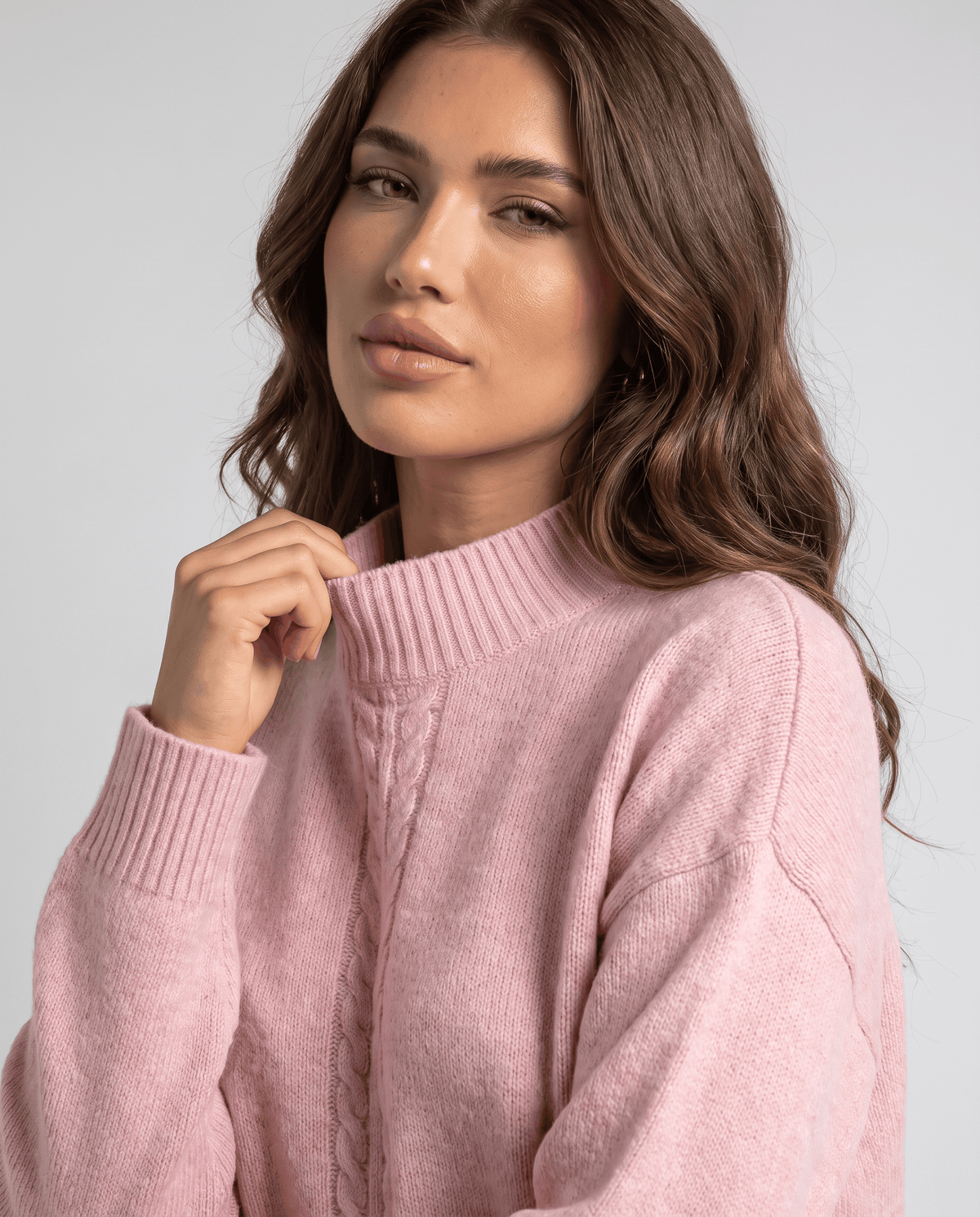 Close-up of the mock neck on the pink knit pullover