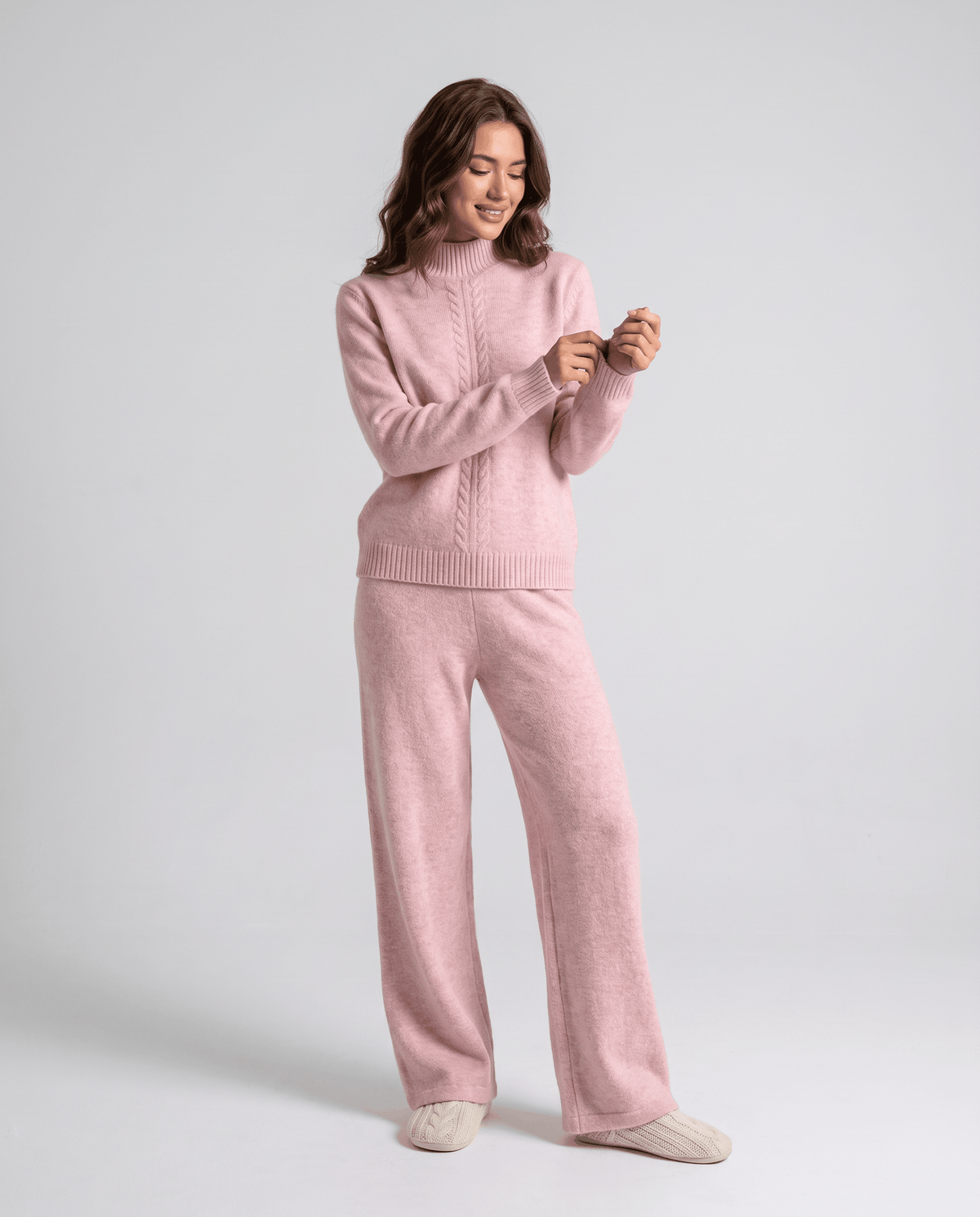 Pink wool loungewear set, front view of the mock-neck pullover with hand at the cuff
