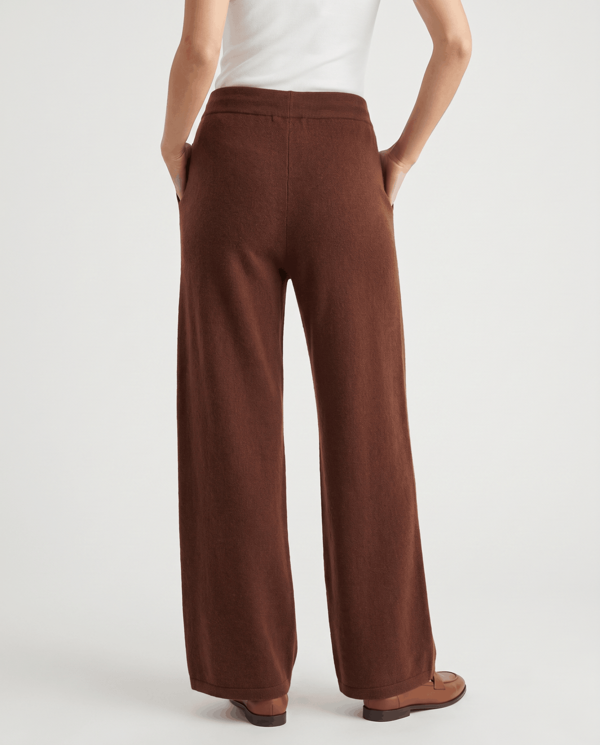 Full back view of brown wide-leg knit pants with loafers