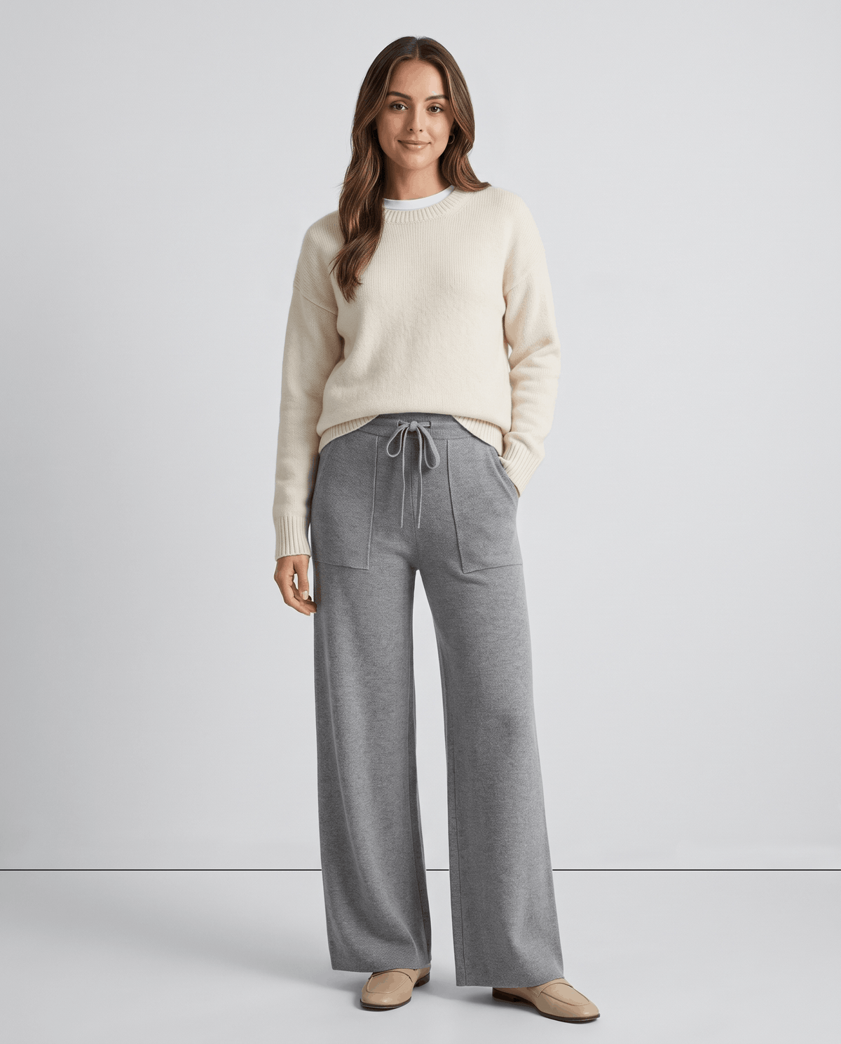 Model in cream sweater and gray high-waisted wide-leg knit pants