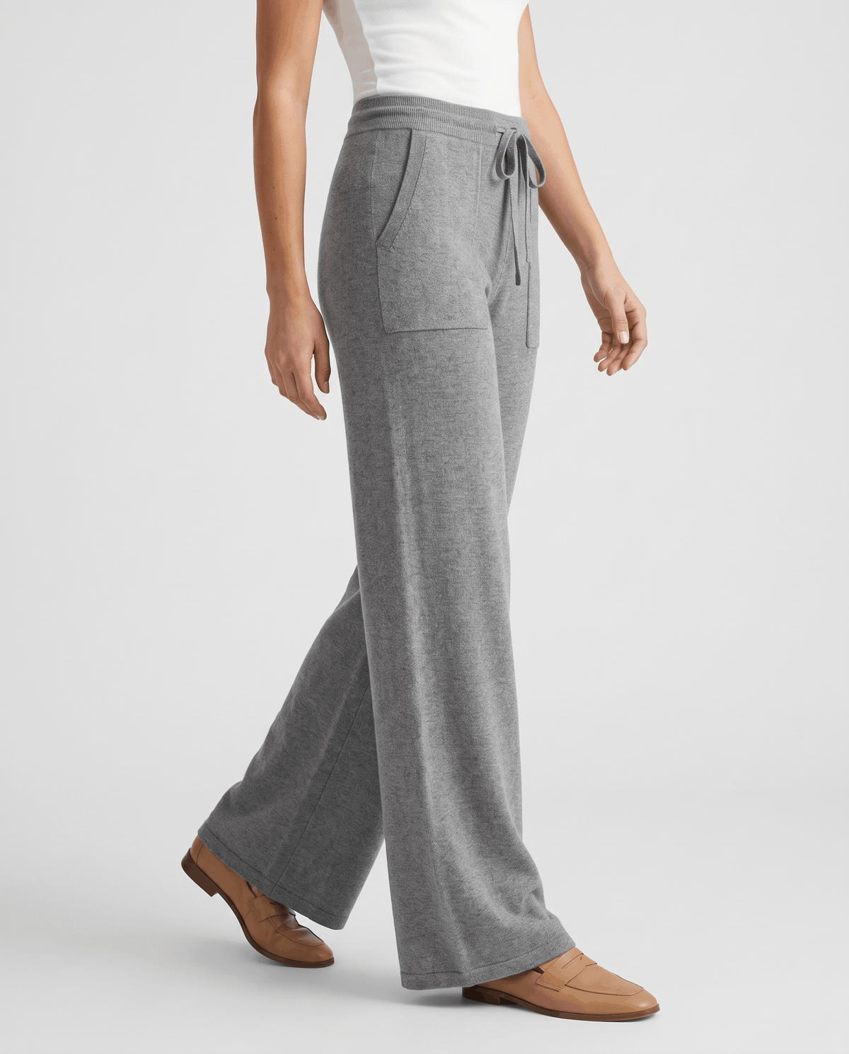Gray heathered knit pants in side view with drawstring tie and loafers