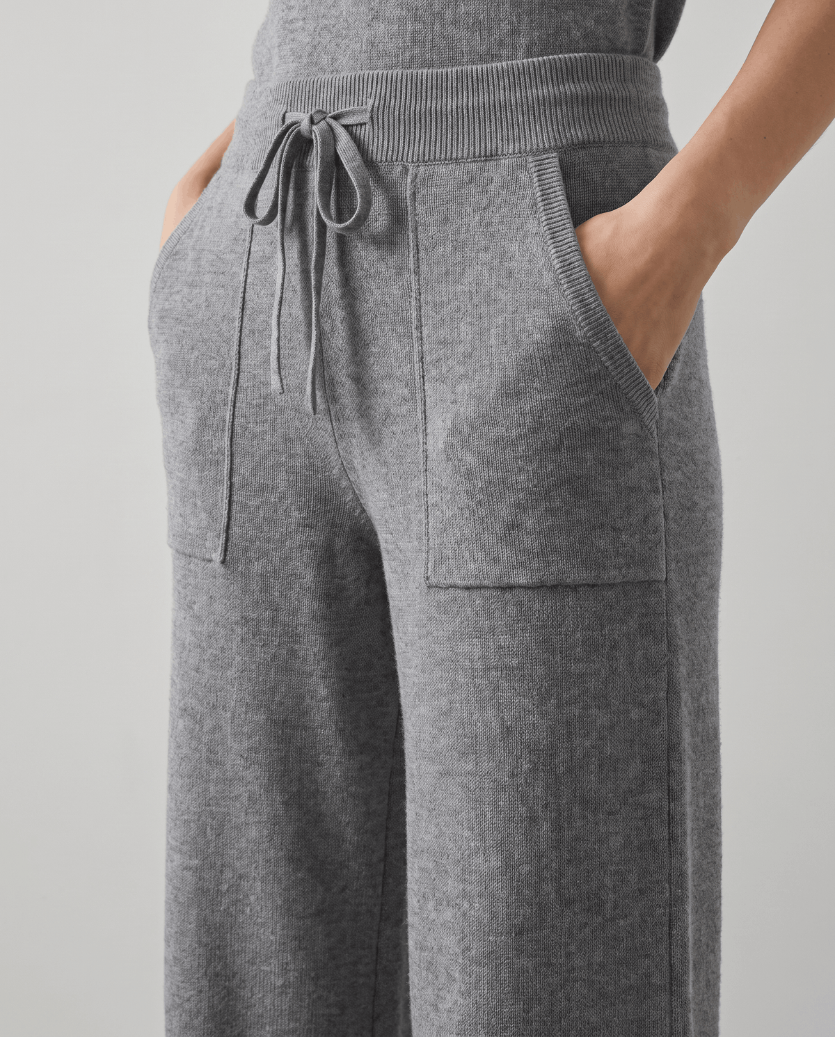 Front close-up of gray drawstring waist and patch pockets