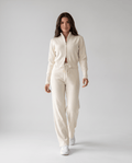 Woman wearing a beige knit cropped zip-up cardigan and wide-leg pants lounge set, front view
