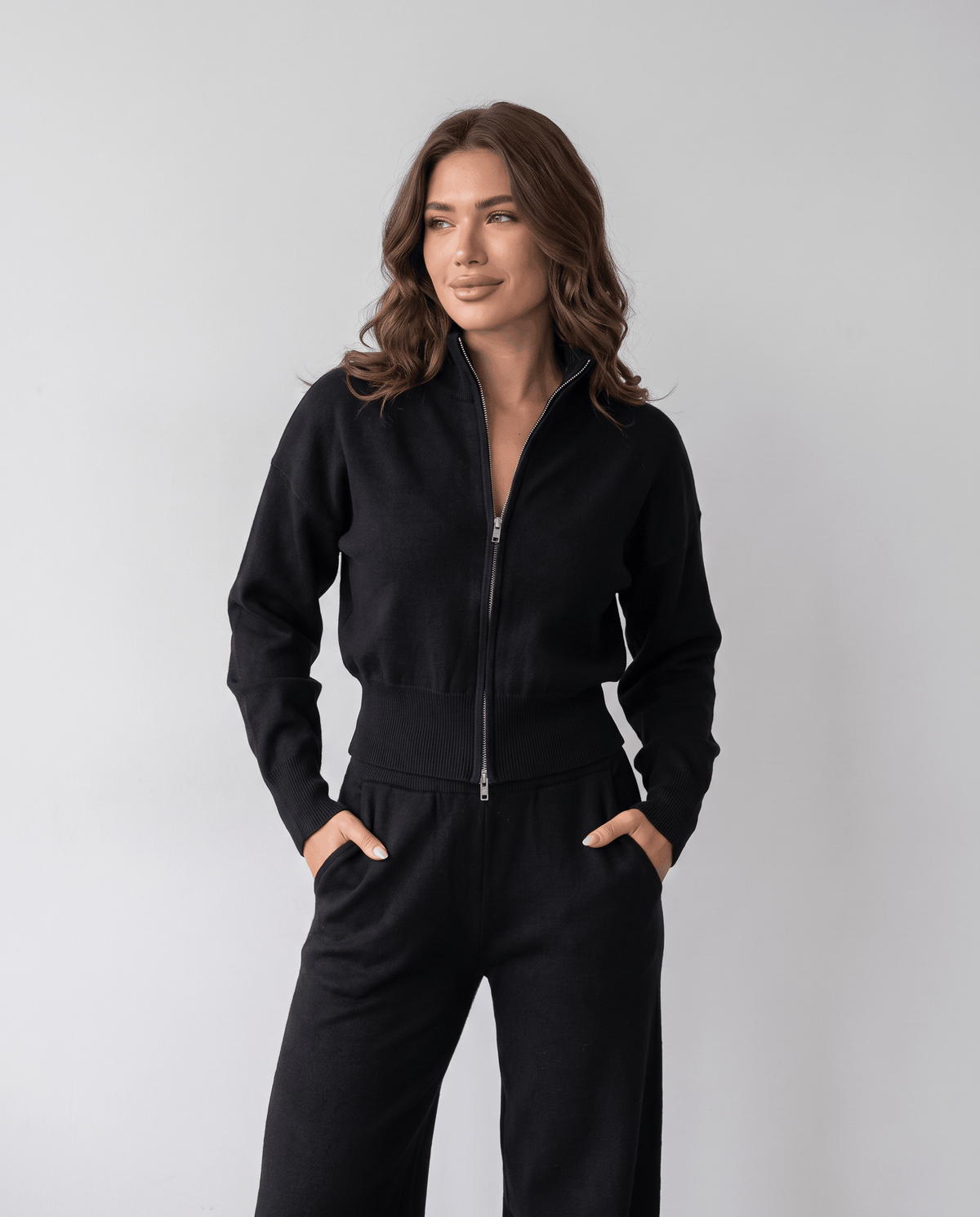 Black knit zip-up cardigan and wide-leg pants lounge set, front view with hands in pockets