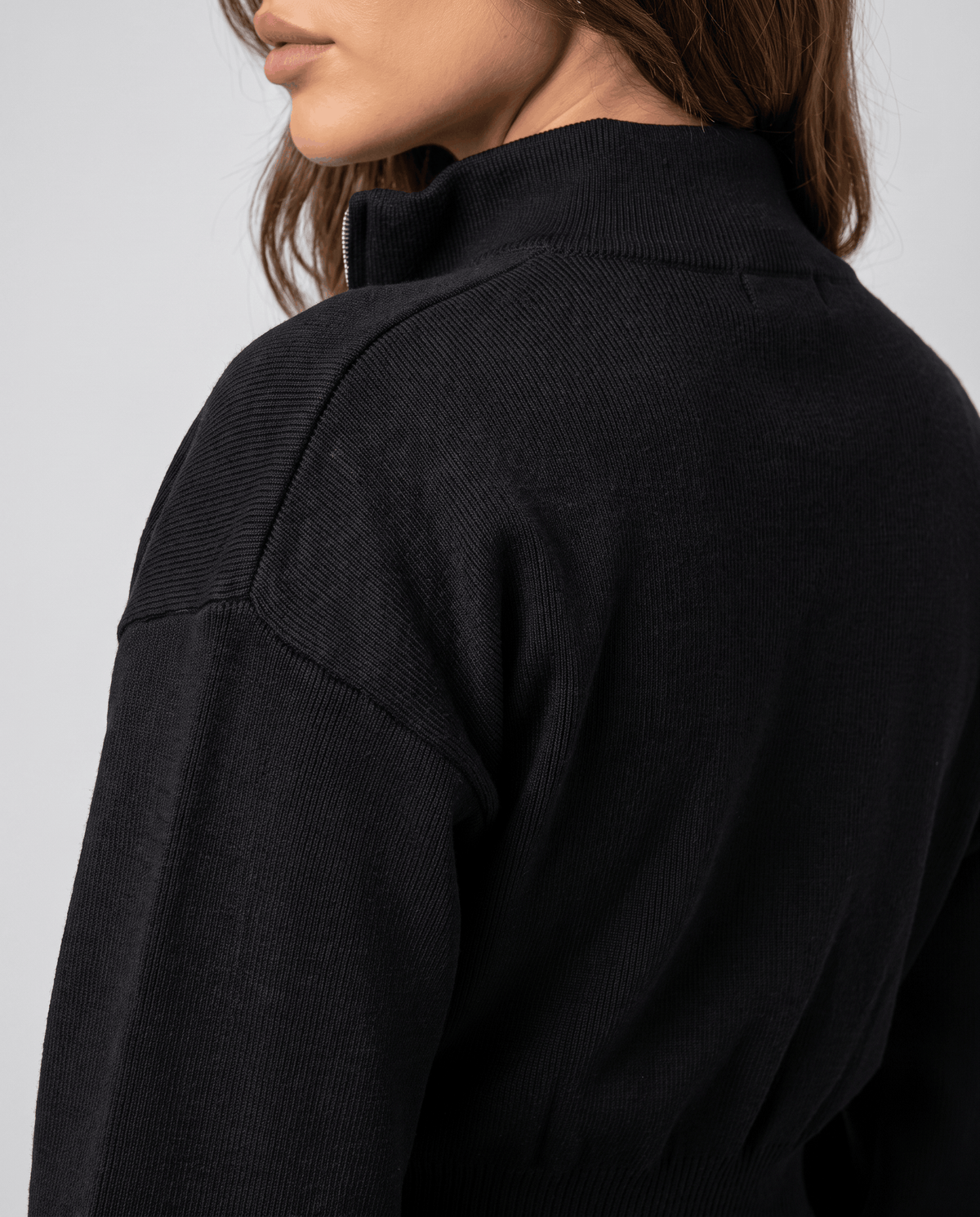 Close-up of the collar and shoulder on the black knit cardigan