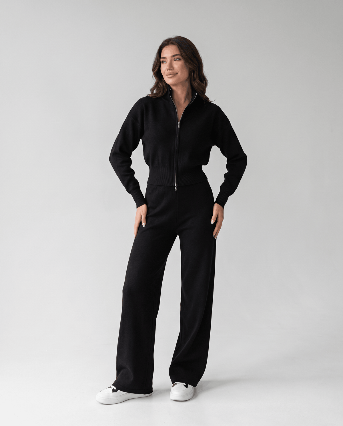 Black cropped zip-up cardigan and wide-leg pants lounge set, three-quarter view with hand on hip