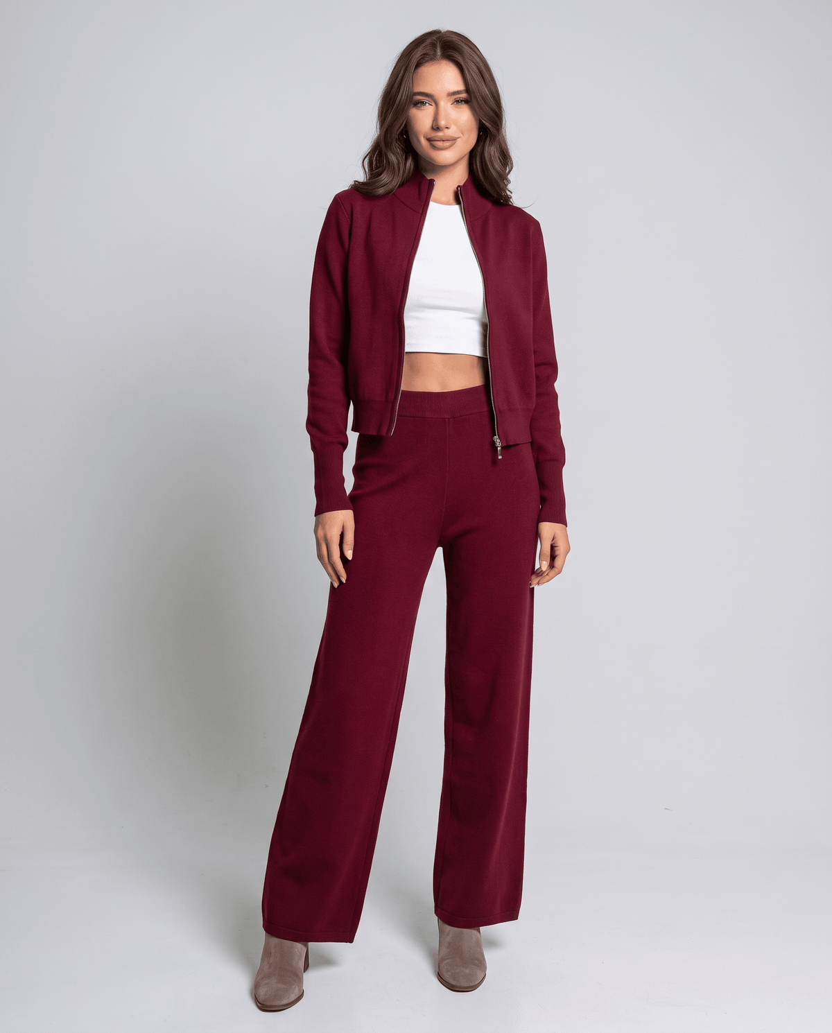 Burgundy cropped zip-up cardigan worn open over a white top, front view