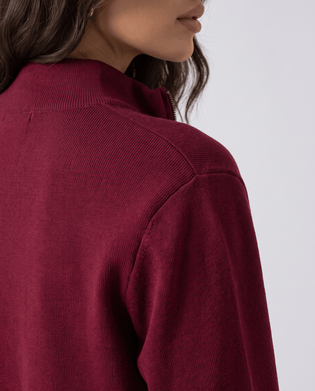 Close-up of the collar and shoulder on the burgundy knit cardigan