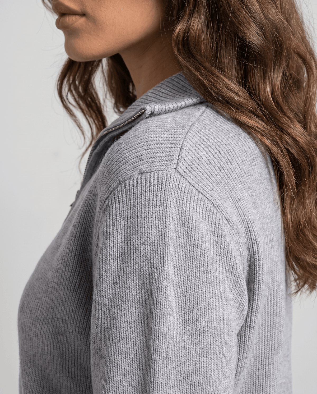Side close-up of the collar and knit texture on the gray cardigan
