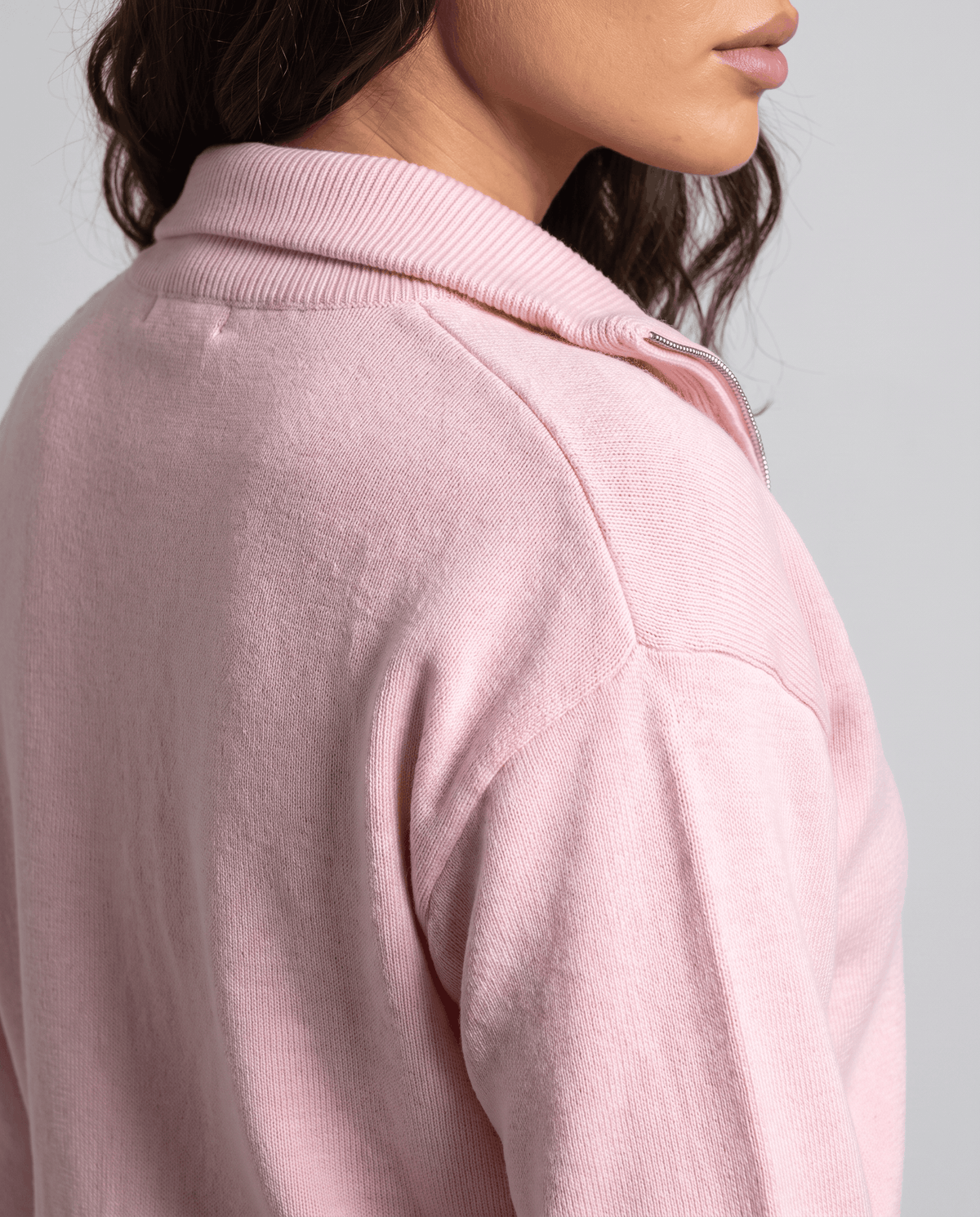 Close-up of the collar on the light pink knit cardigan